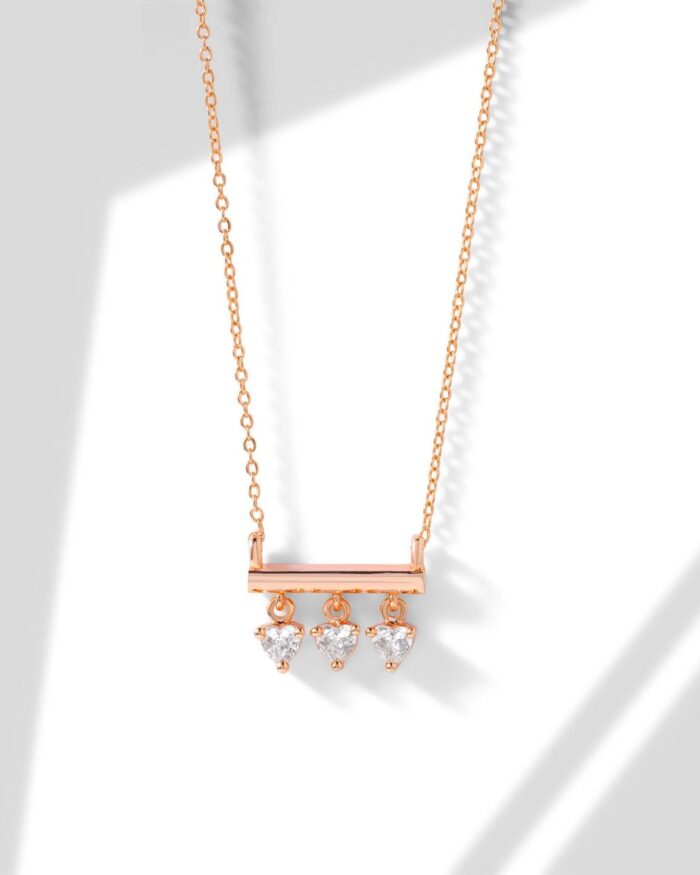 Diamanset Diamond Trio Bar Necklace in rose gold, a slim horizontal bar with three heart-cut diamonds suspended below, on a white background
