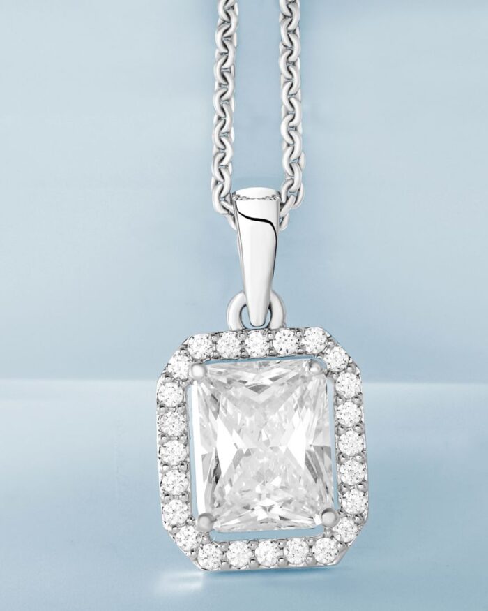 Diamanset Emerald Halo Pendant, 18k white gold pendant with emerald-cut centre stone and pave diamond halo, white background