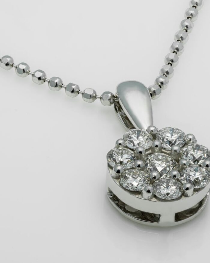 Diamanset Halo Cluster Pendant in white gold, a round cluster of diamonds on a faceted bead chain, on a white background