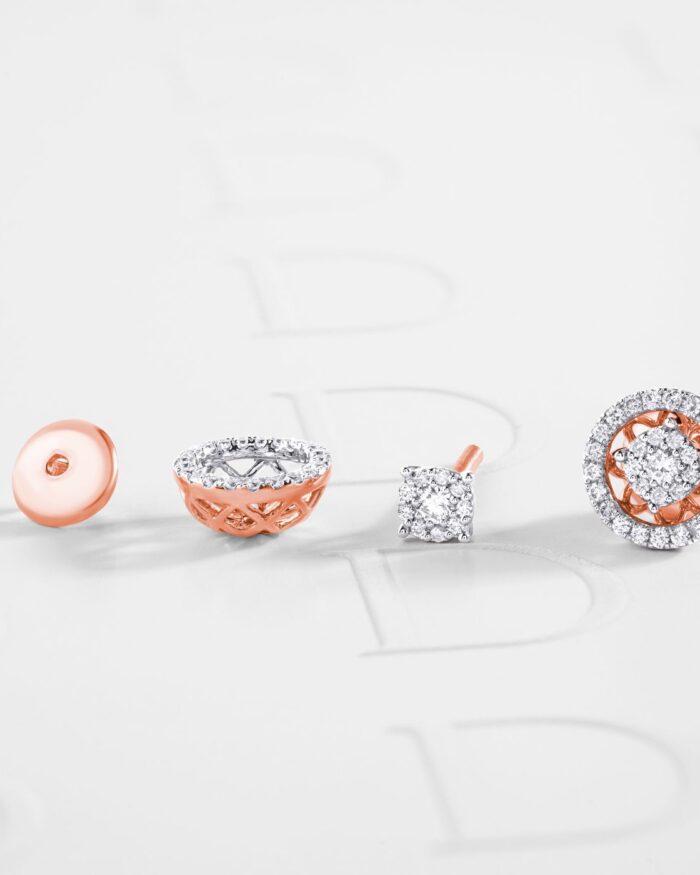 Diamanset Halo Diamond Studs in rose gold, each round centre stone framed by a diamond halo, on a white background