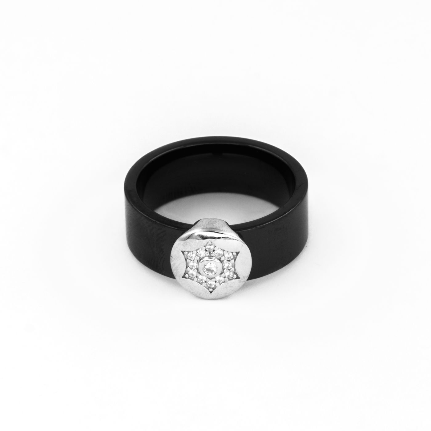 Diamanset Onyx Signet Ring, a wide black band with a silver medallion set with a diamond rosette, on a white background