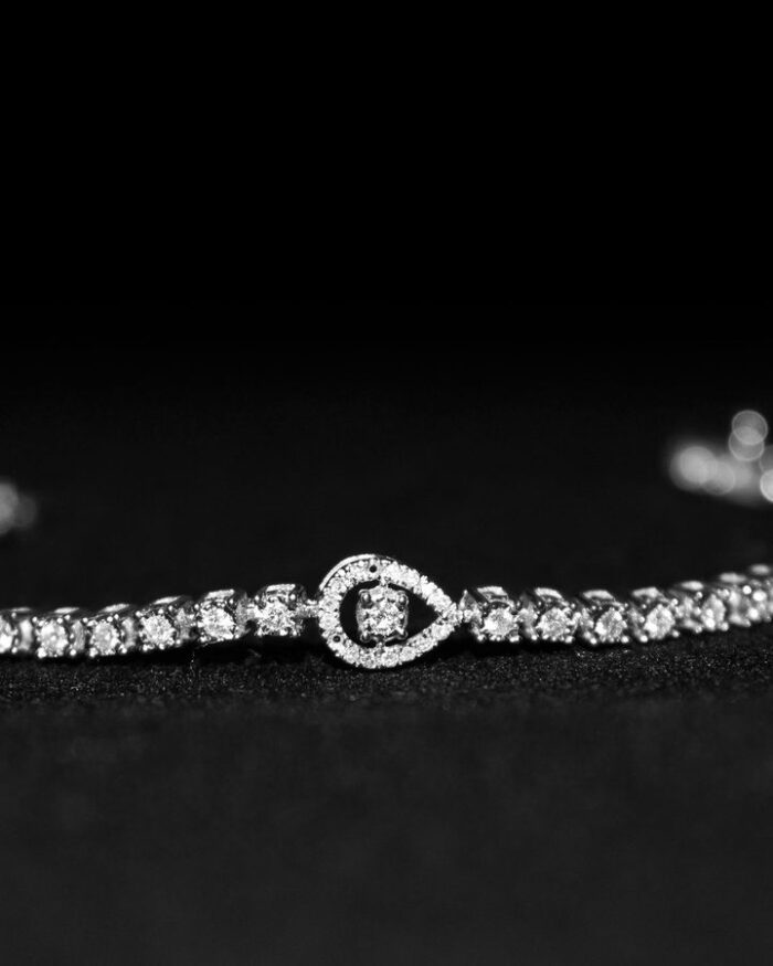 Diamanset Pear Halo Tennis Bracelet, 18k white gold diamond tennis bracelet with pear-shaped halo link accent, black background
