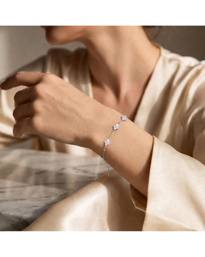 Diamanset Moissanite Cross Bracelet, fine silver chain with a moissanite cross and clover stations on the wrist